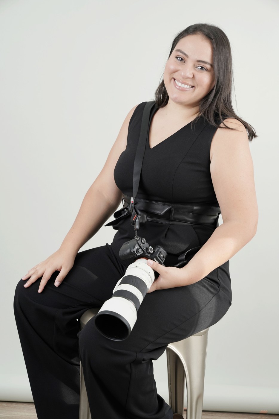 Erika Ayales Bracero, owner and photographer of Small Hearts Photography, holding her camera
