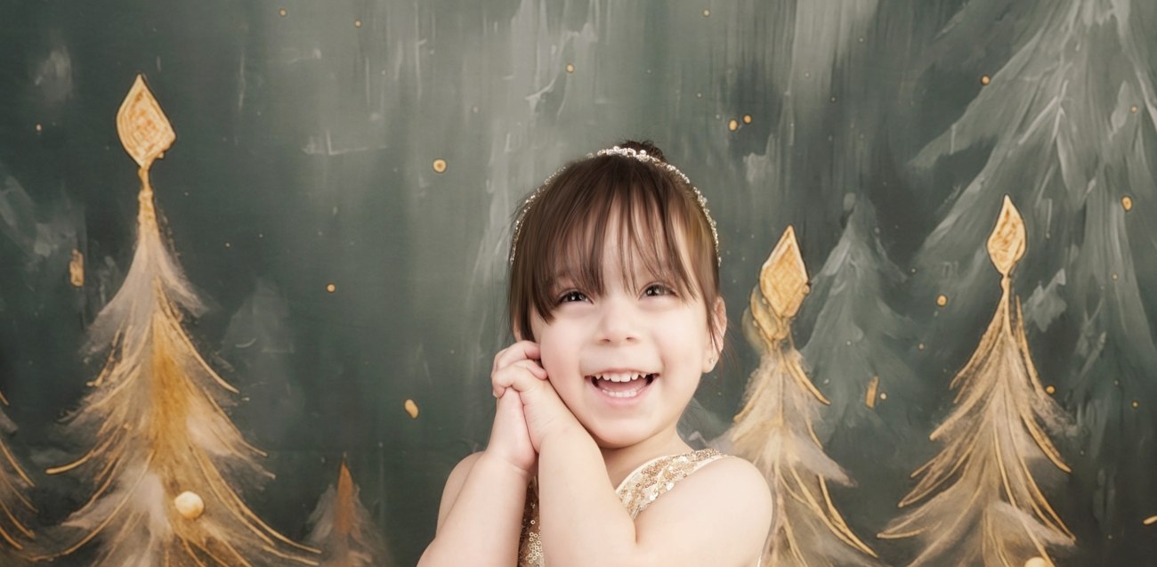 Toddler girl laughing in a gold sequin dress during a holiday portrait session